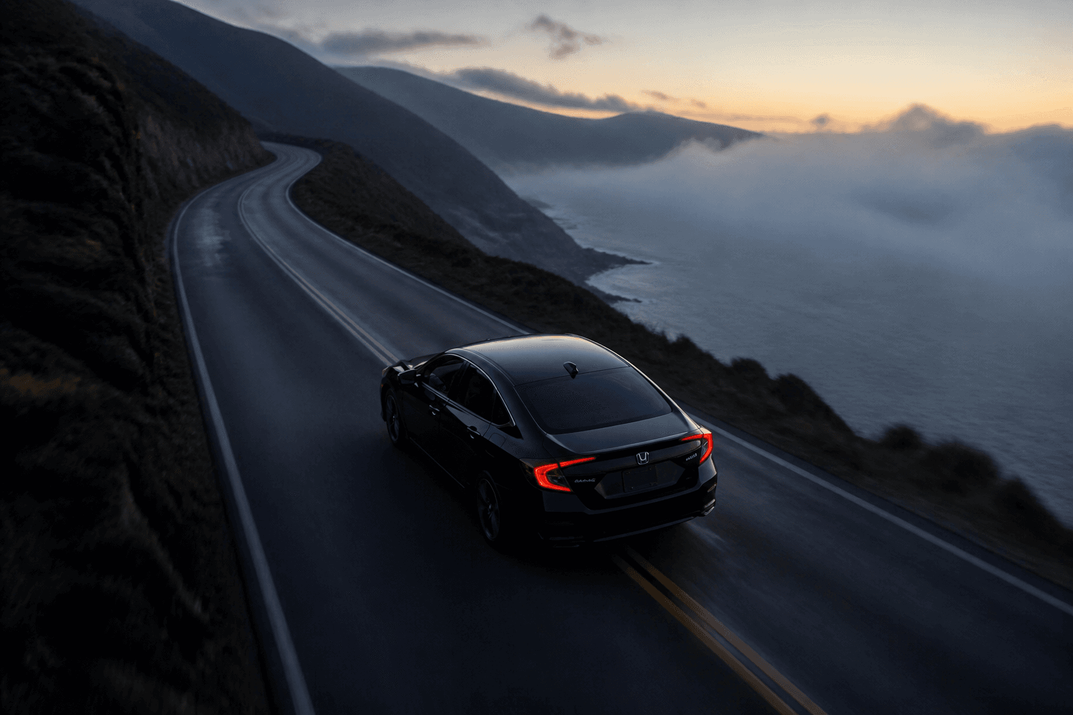 Black Honda Civic on a cinematic coastal highway